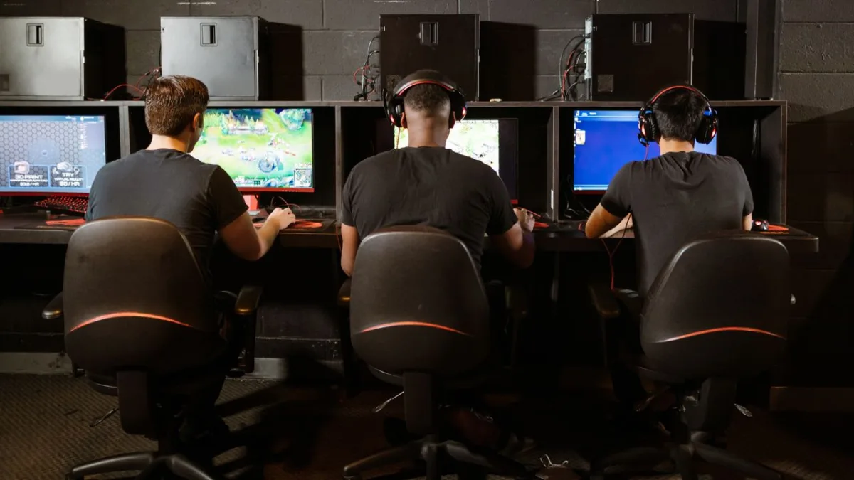 Players at a LAN setup tapping keyboards fast during competitive matches