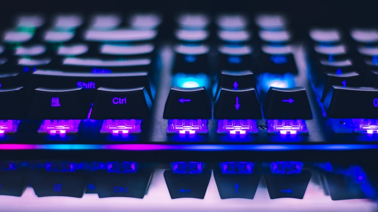 Close-up of a RGB mechanical gaming keyboard showing Shift, Ctrl, and arrow keys — the cluster most affected by ghosting during gameplay