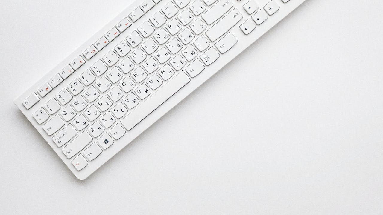 Top-down view of a compact wireless keyboard with all letter keys visible — used for testing ghosting and N-key rollover behaviour