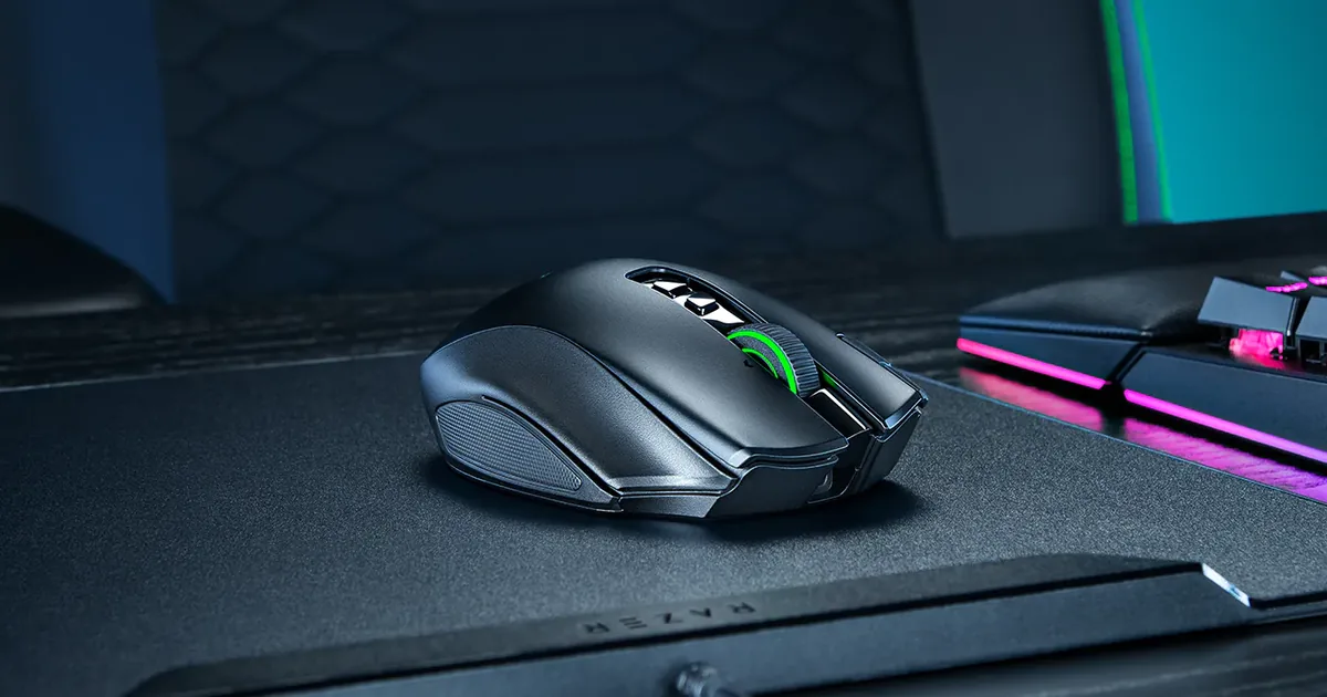 The Razer Naga V3 Pro on a mouse mat beside a gaming keyboard during a test setup